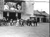 A funeral procession passing a Phan Thiet movie house.