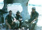 Guidotti, Rodriguez and Platson resting inside a bombed out church