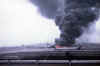 Smoke billows from a crashed C-130.